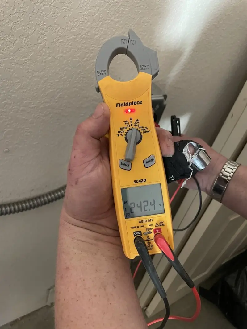 Voltage testing with clamp meter during Electrical Installation Services in World Golf Village